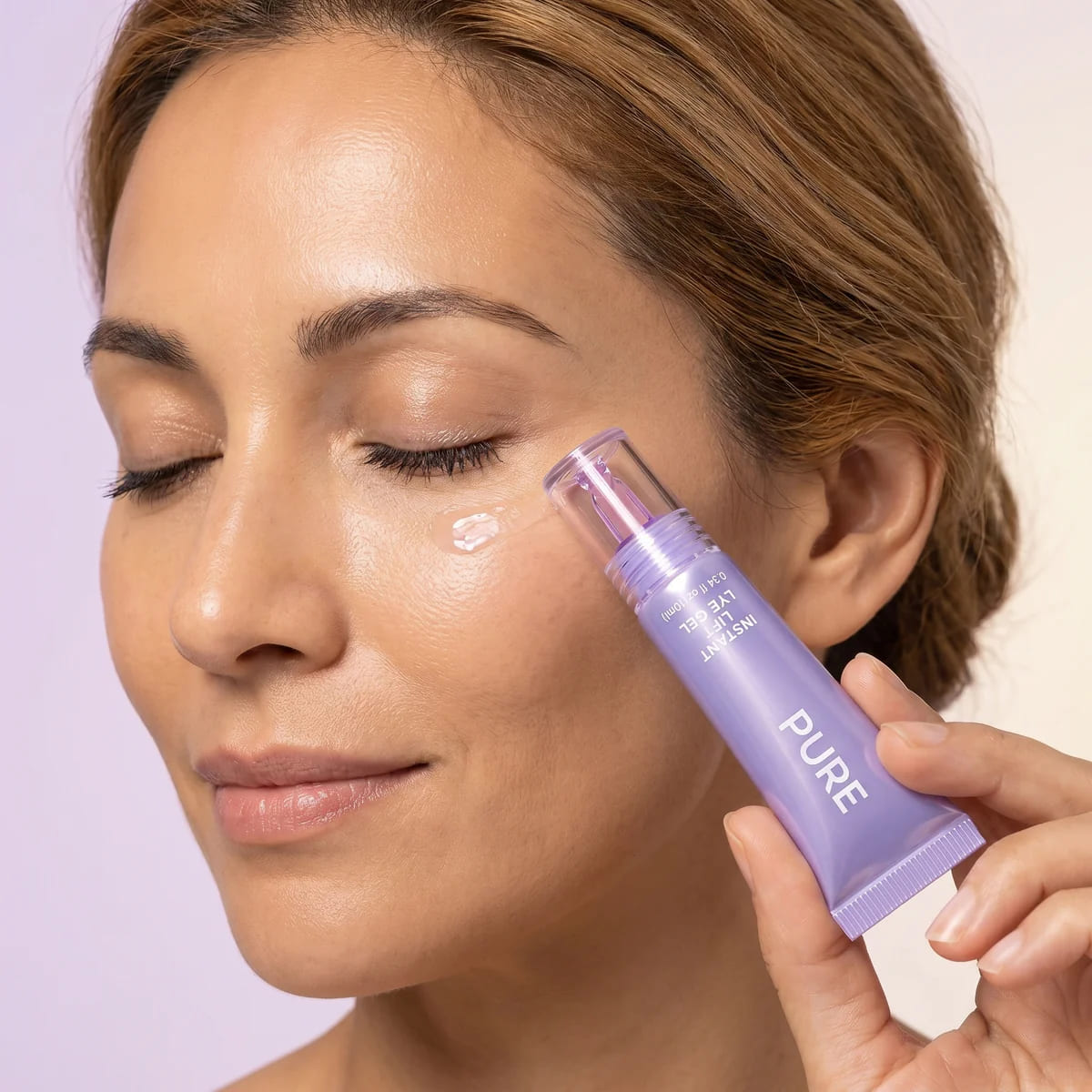 Woman using the eye gel